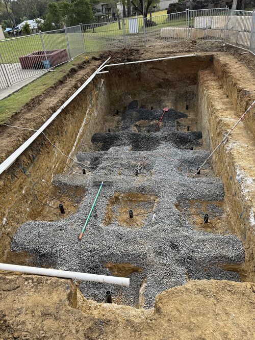Screw piles capped and set in gravel in an excavated swimming pool foundation in Ipswich